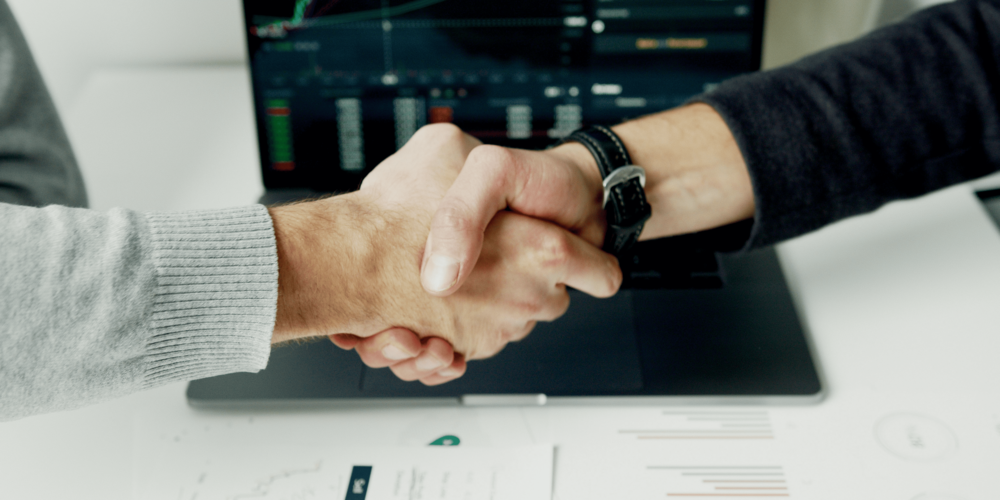 Business leaders shaking on their software escrow agreement.